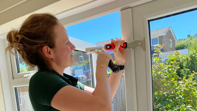 Katie of M and K Locksmiths repairing UPVC window